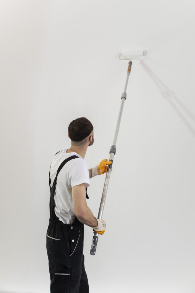 medium shot young man painting wall